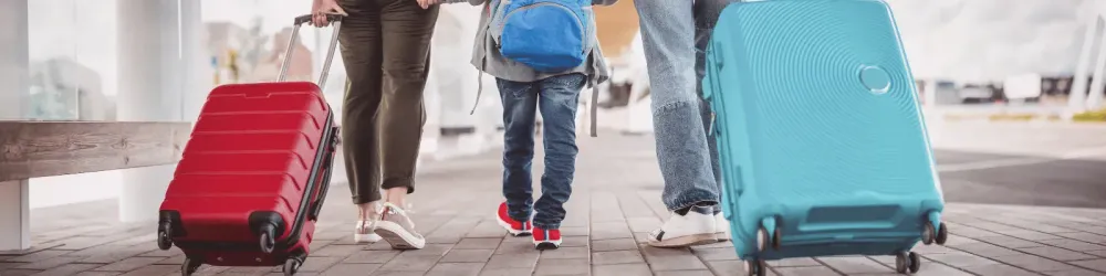 Family walking at airport with luggage